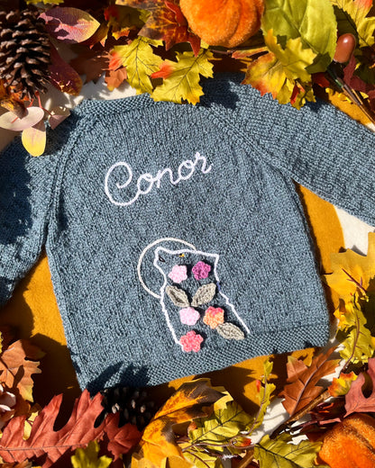 Little Flower Knits personalised blue knitted baby sweater named Conor with floral wolf motif unique boy wolf gift ideas