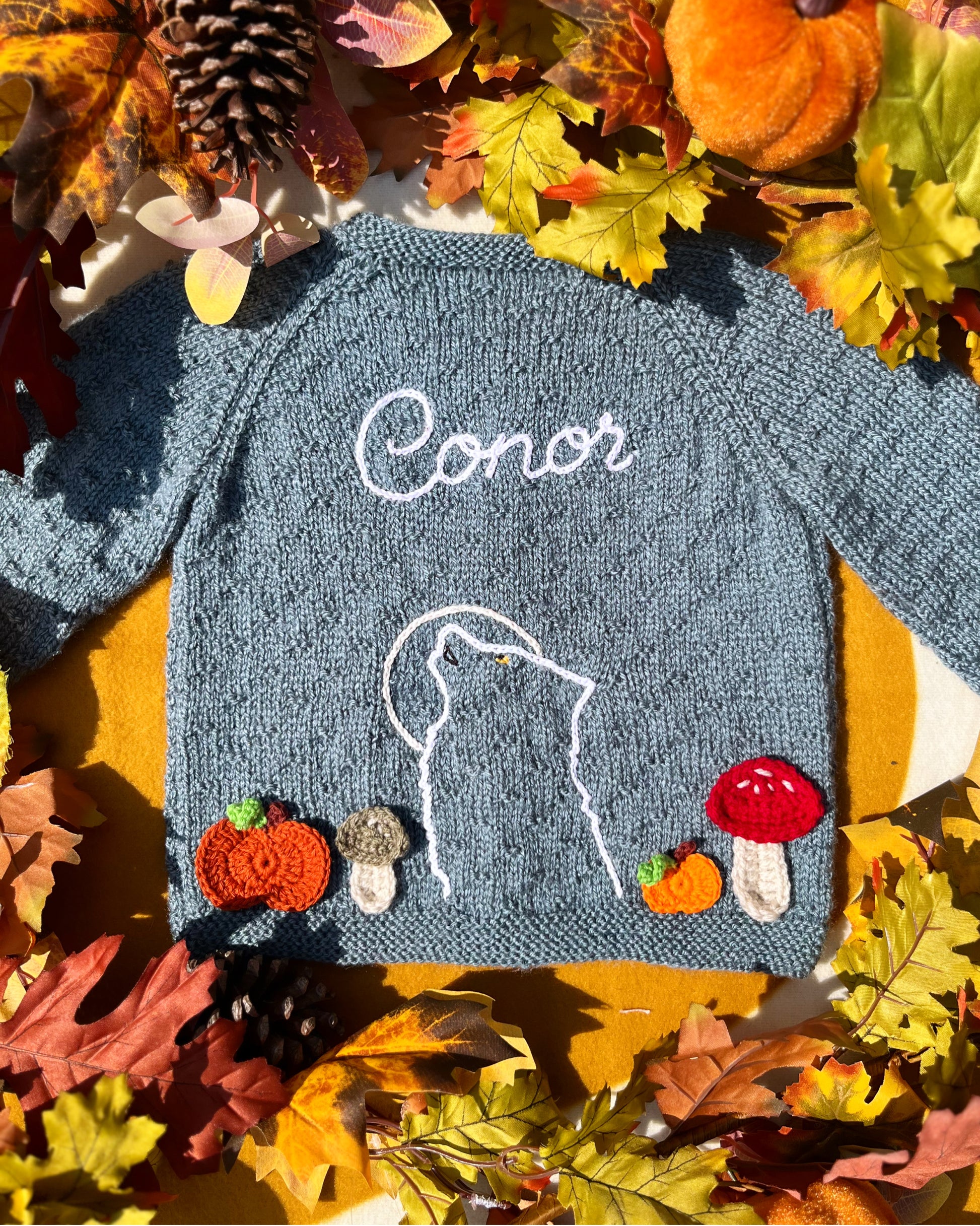 Little Flower Knits personalised blue knitted jumper with wolf outline name Conor and autumn mushrooms unique boy wolf gift ideas