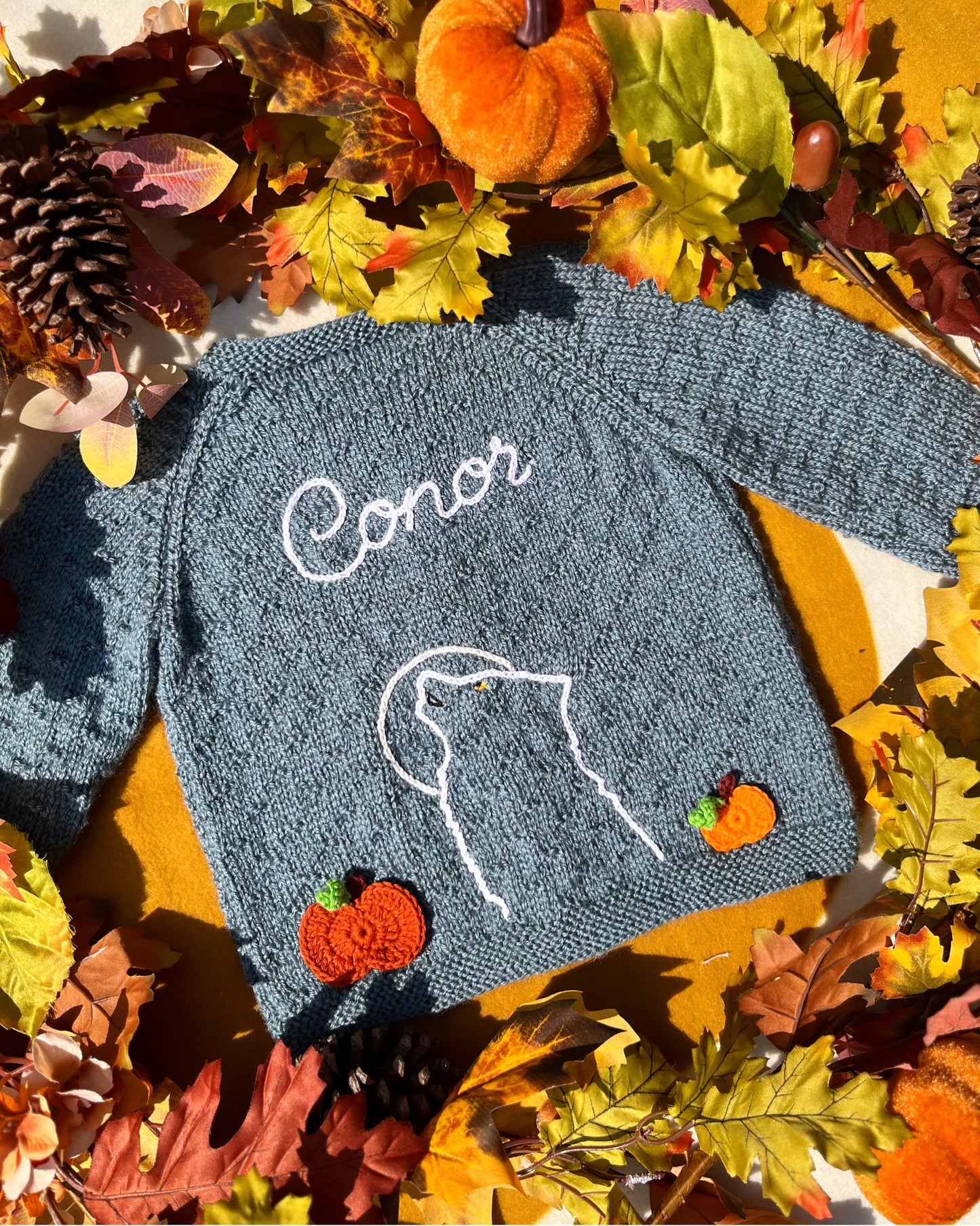 Hand knitted baby cardigan with embroidered wolf outline and name Conor in blue grey ideal unique boy wolf gift ideas