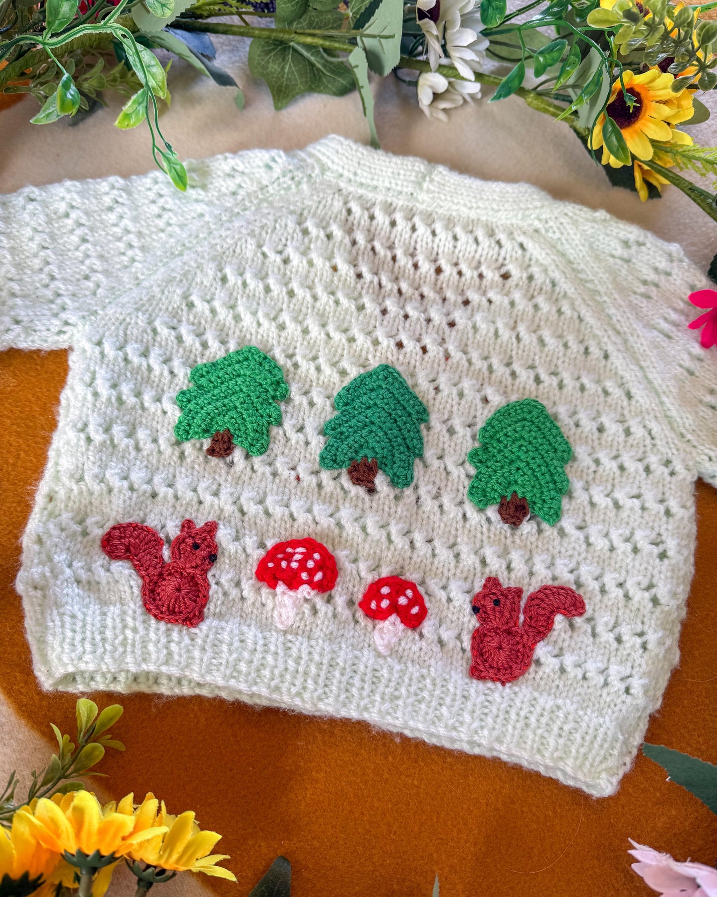 Handmade baby cardigan 9-12 months with charming woodland motifs of trees and squirrels