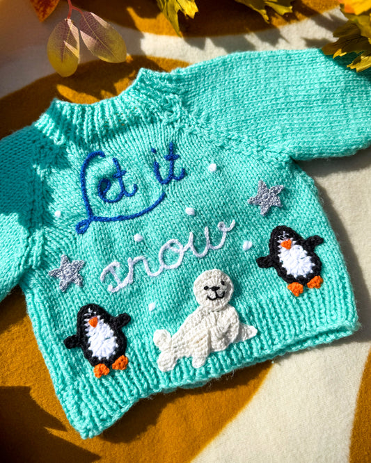 Handmade baby cardigan UK in turquoise with penguin and seal embroidery for winter-themed outfits