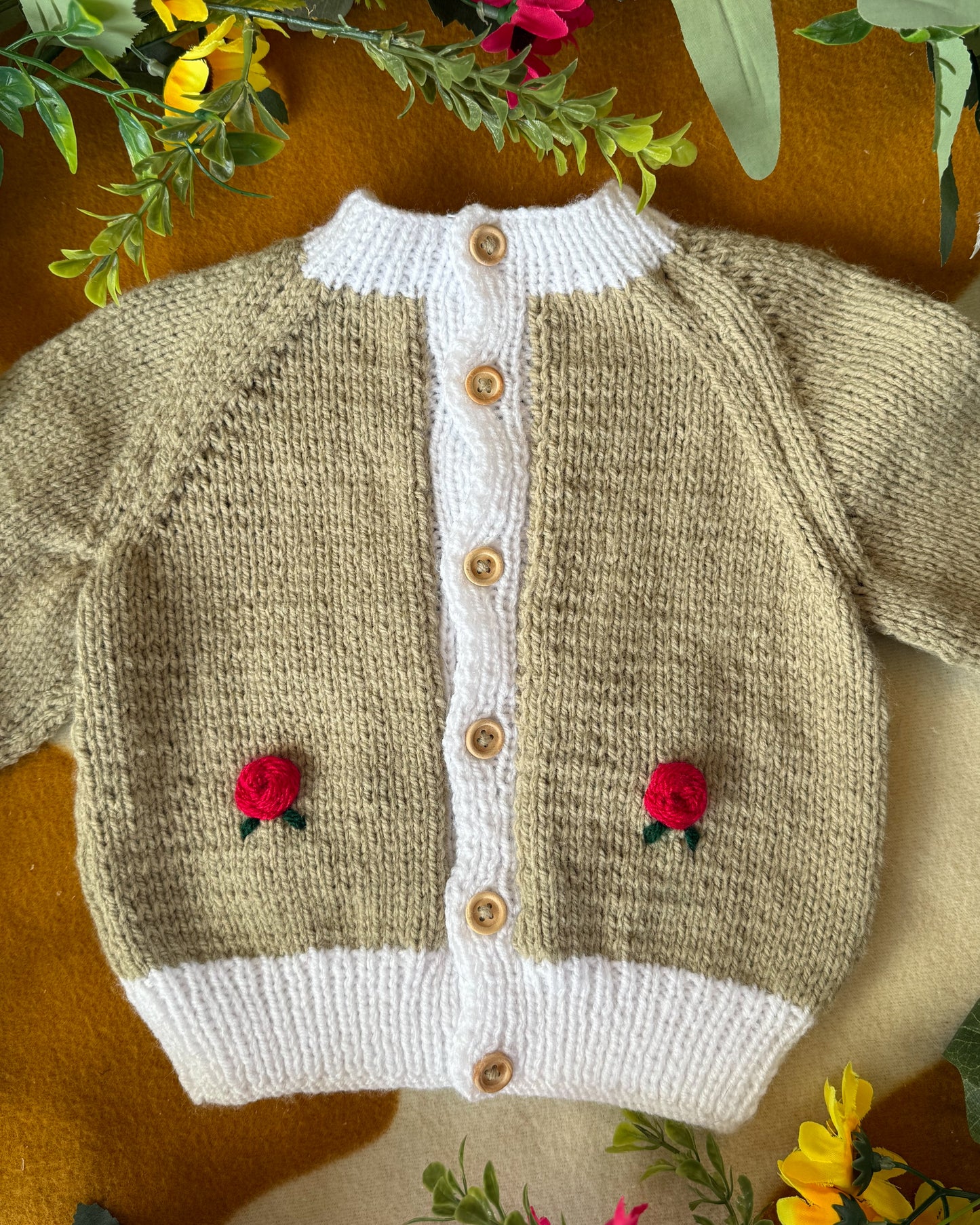 Handmade baby cardigan UK with floral embroidery and wooden buttons for infants