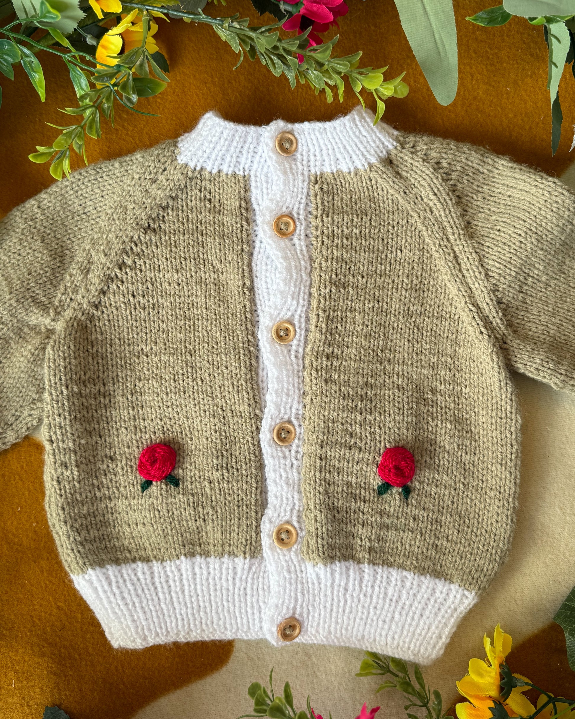 Handmade baby cardigan UK with floral embroidery and wooden buttons for infants