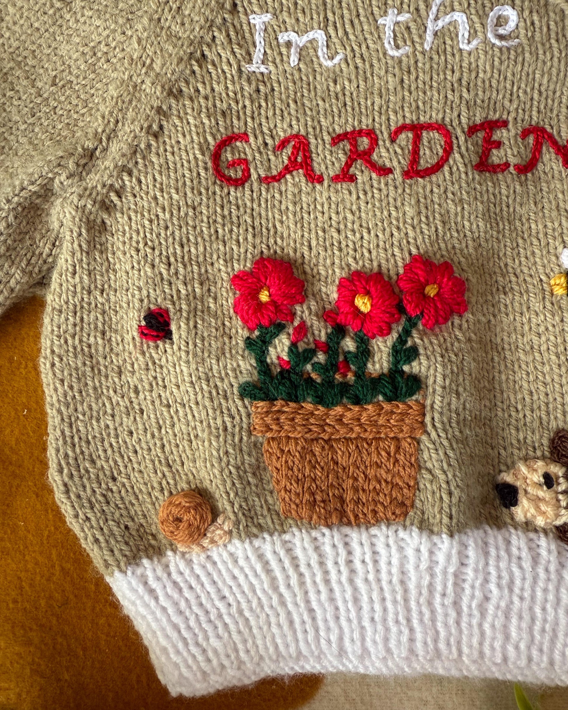 Little Flower Knits handmade baby cardigan UK featuring floral embroidery and garden theme