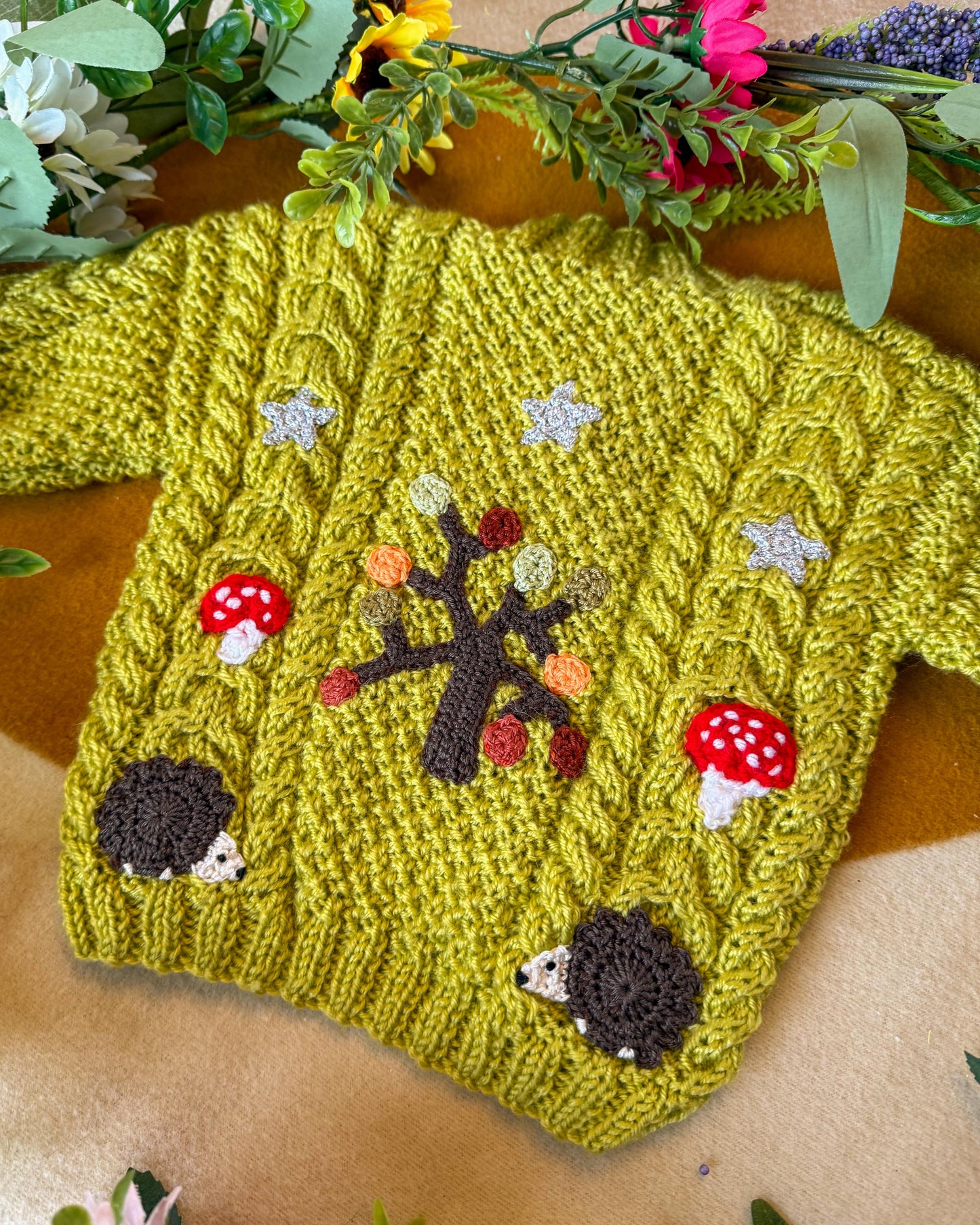 Handmade baby cardigan UK in yellow with cute hedgehog and tree patterns for infants
