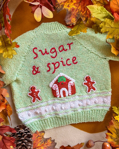 Handmade baby cardigan UK in green featuring 'Sugar & Spice' with gingerbread decorations
