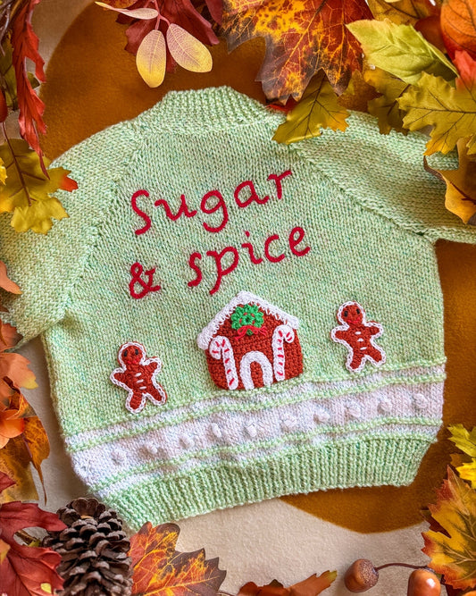 Handmade baby cardigan UK in green featuring 'Sugar & Spice' with gingerbread decorations