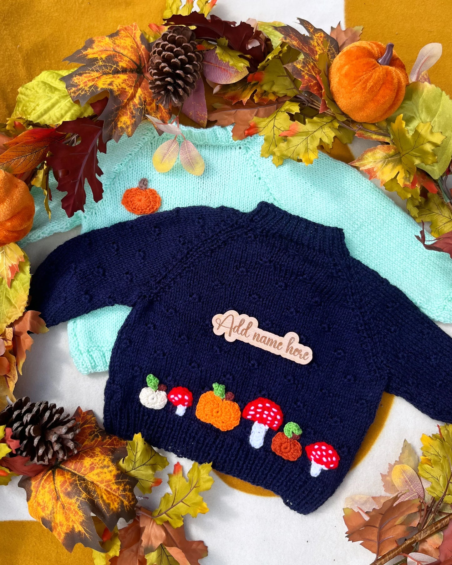 Knitted navy toddler jumper with pumpkin mushroom appliques and mint jumper among autumn leaves custom pumpkin outfit for toddlers