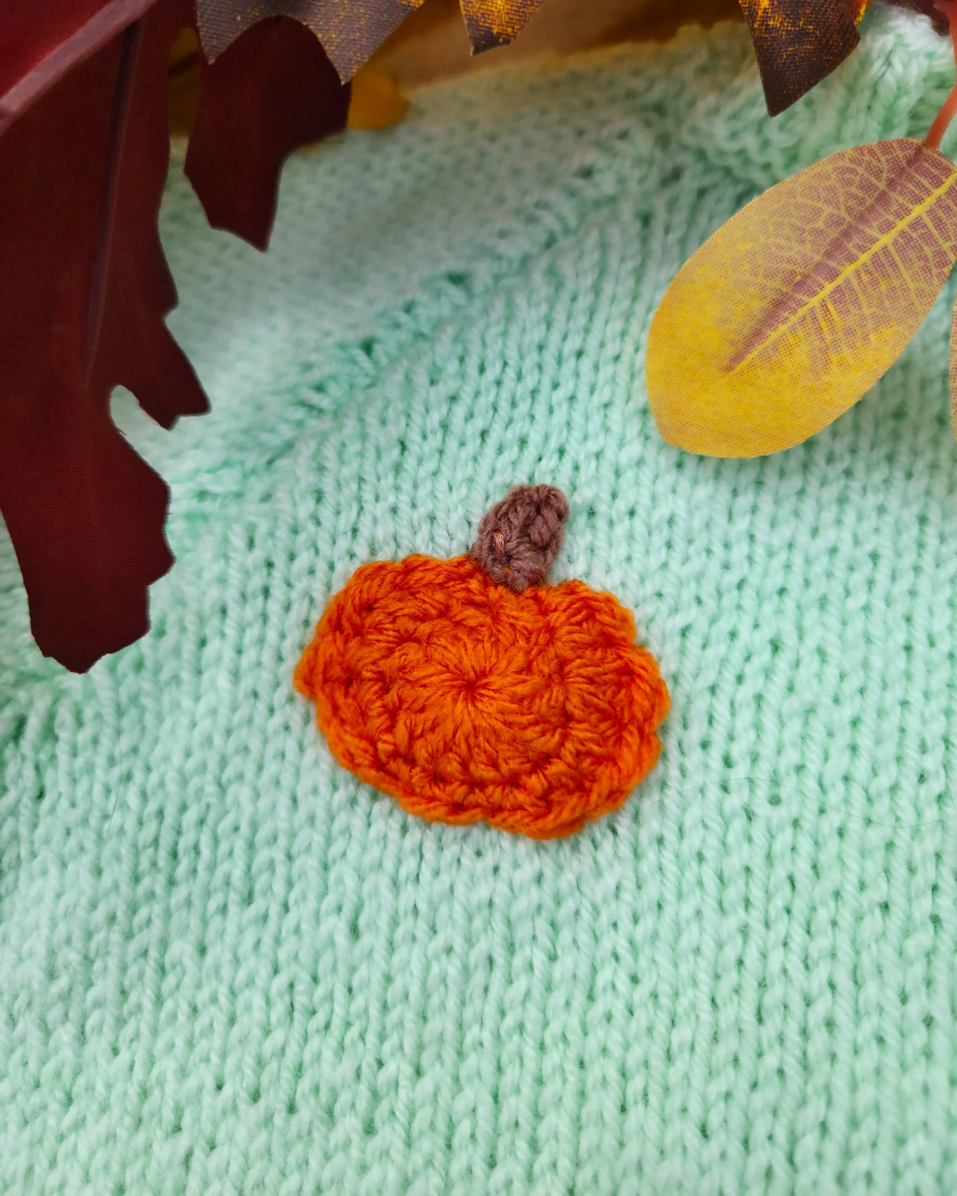 Mint green knitted toddler jumper with small crocheted orange pumpkin applique and leaves custom pumpkin outfit for toddlers
