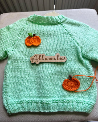 Mint green knitted toddler jumper with two orange pumpkin appliques and wooden name sign custom pumpkin outfit for toddlers