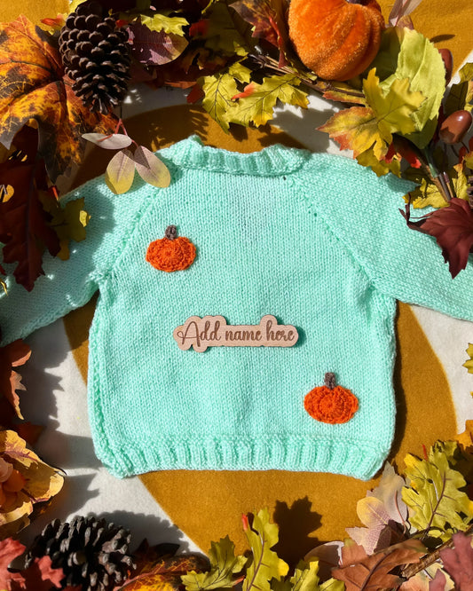 Mint green knitted sweater with orange crochet pumpkins and wooden name plaque custom pumpkin outfit for toddlers