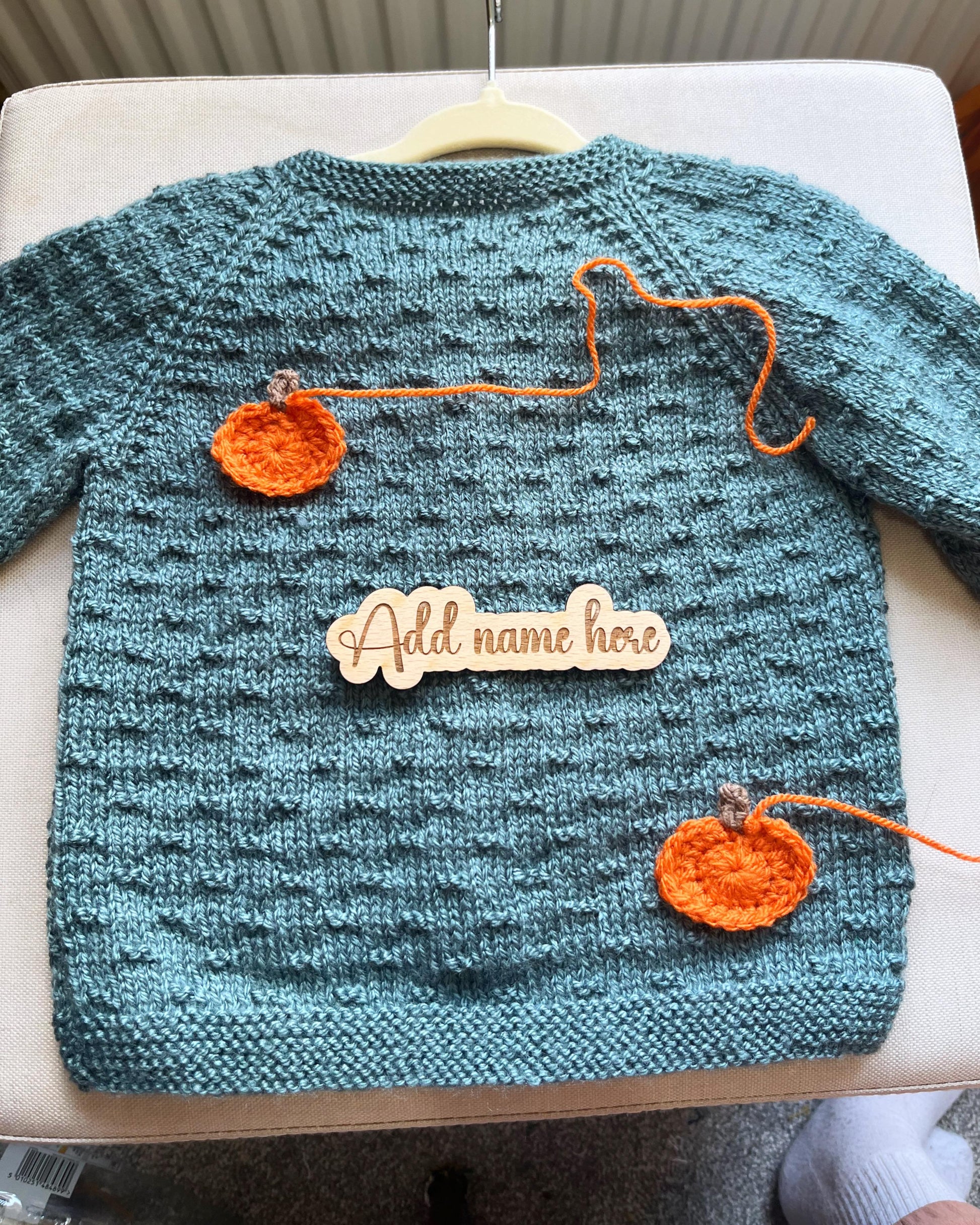 Teal handknit toddler sweater with two crocheted pumpkins and wooden name plaque custom pumpkin outfit for toddlers