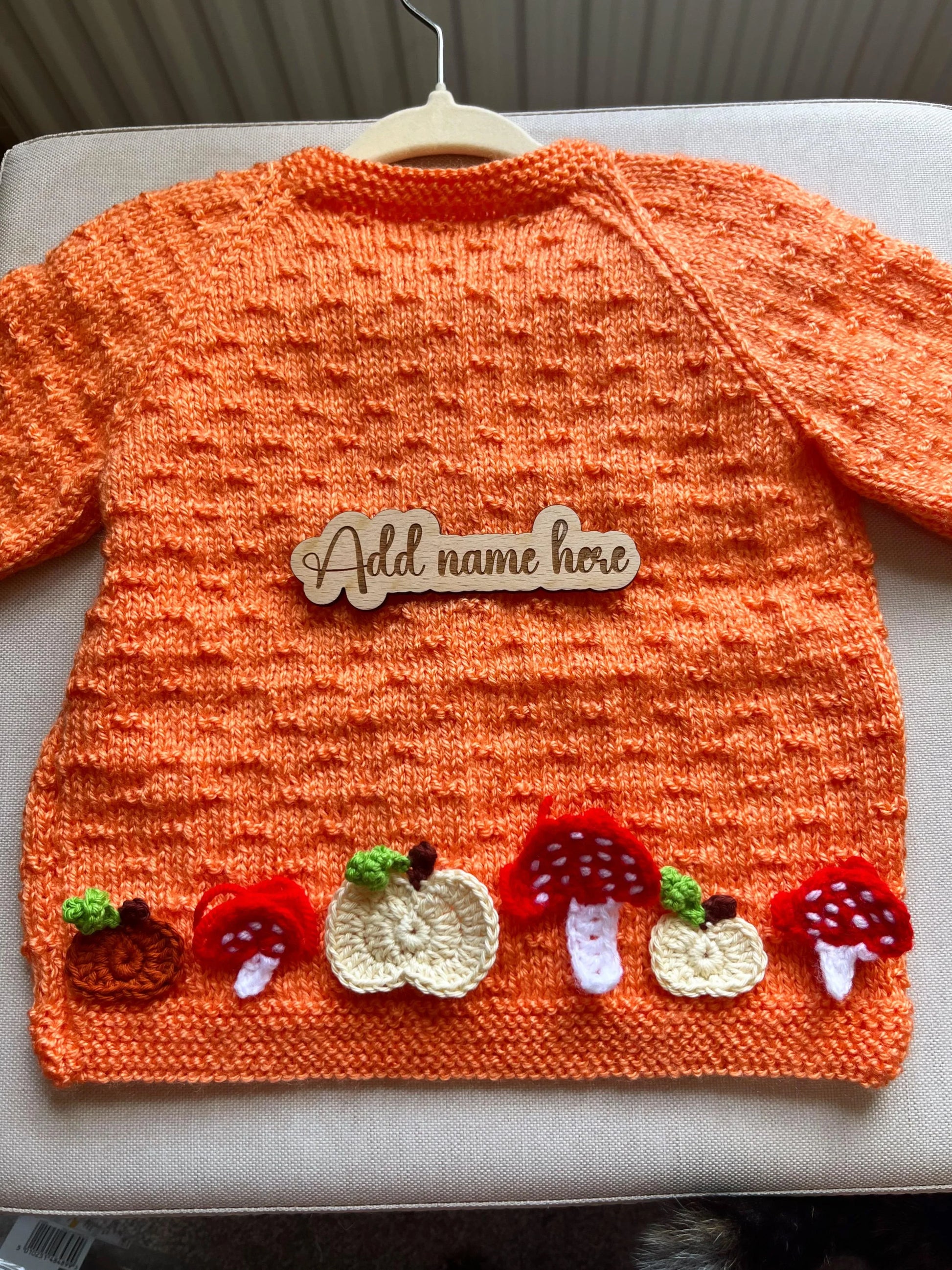 Orange baby sweater with pumpkin and toadstool appliques and wooden name tag hand-knitted pumpkin and toadstool costume