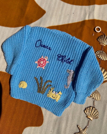 Handmade ocean theme baby knitwear UK blue knitted baby jumper with sea creatures and initials by Little Flower Knits