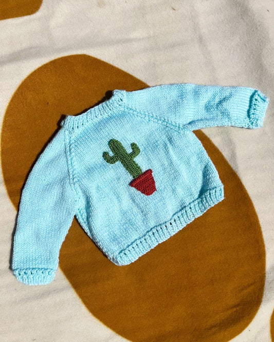 Little Flower Knits personalised baby boy cardigan in light blue with a cactus design on the front