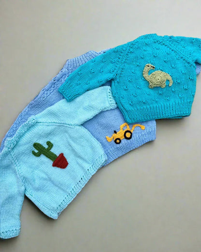 Personalised baby boy cardigan by Little Flower Knits with knitted animal and plant appliques