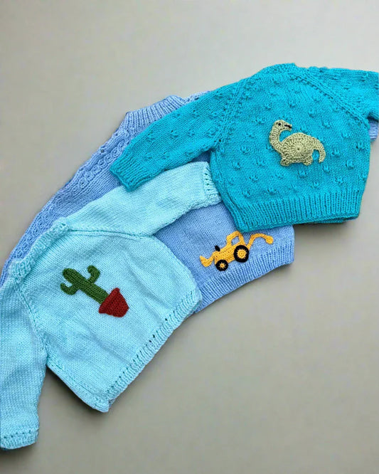 Personalised baby boy cardigan by Little Flower Knits with knitted animal and plant appliques