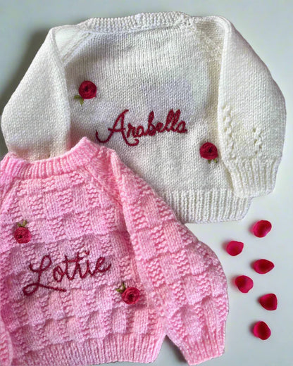 Personalised rose baby cardigan in white and pink with embroidered names and decorative rose buttons