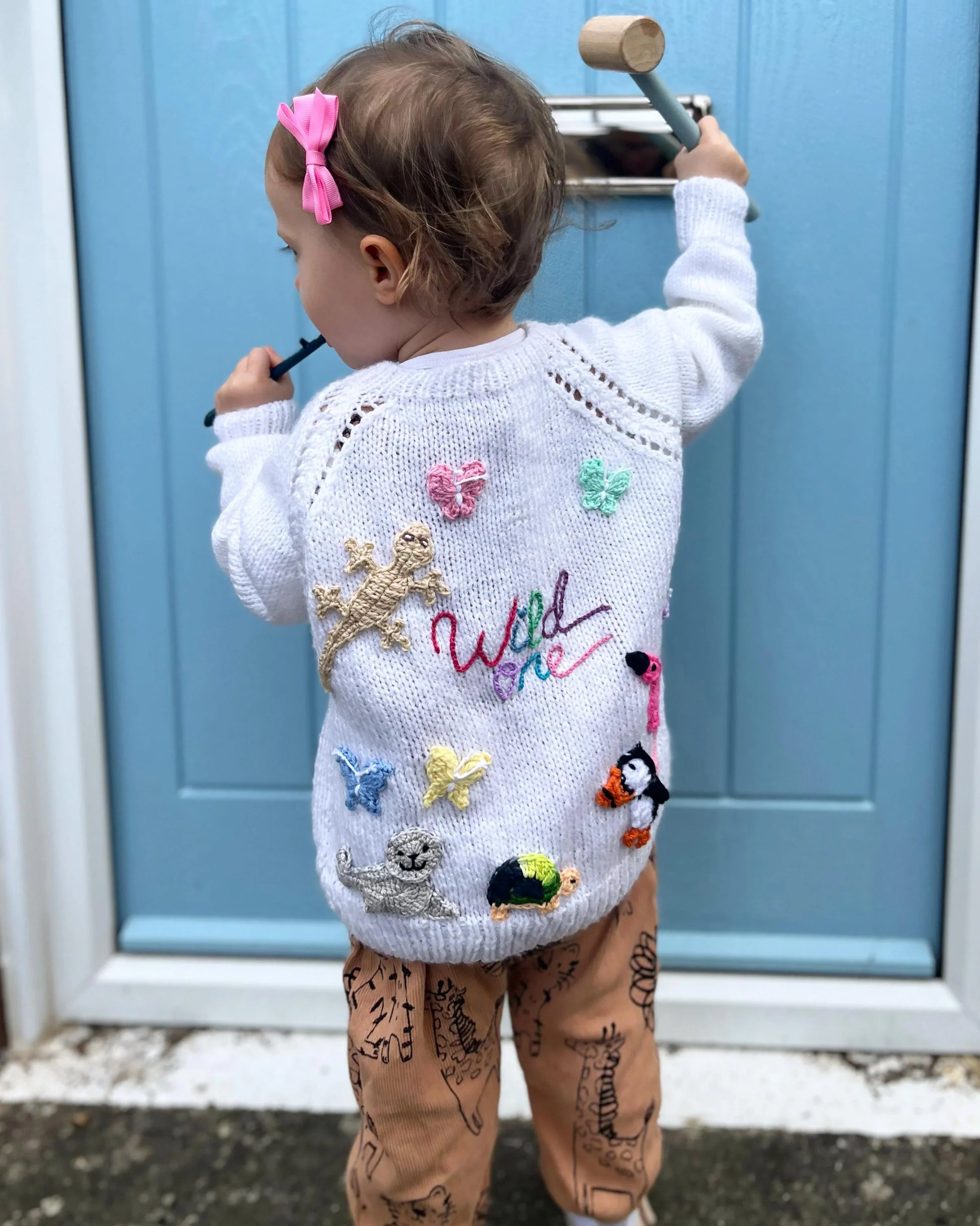 Child wearing a unique birthday gift for 1-5 year olds cardigan with colourful embroidered animals and butterflies