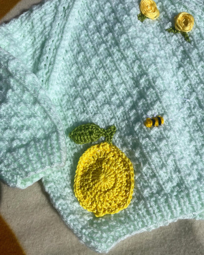 Lemon embroidery cardigan for babies with yellow crocheted lemon and small bee detail by Little Flower Knits