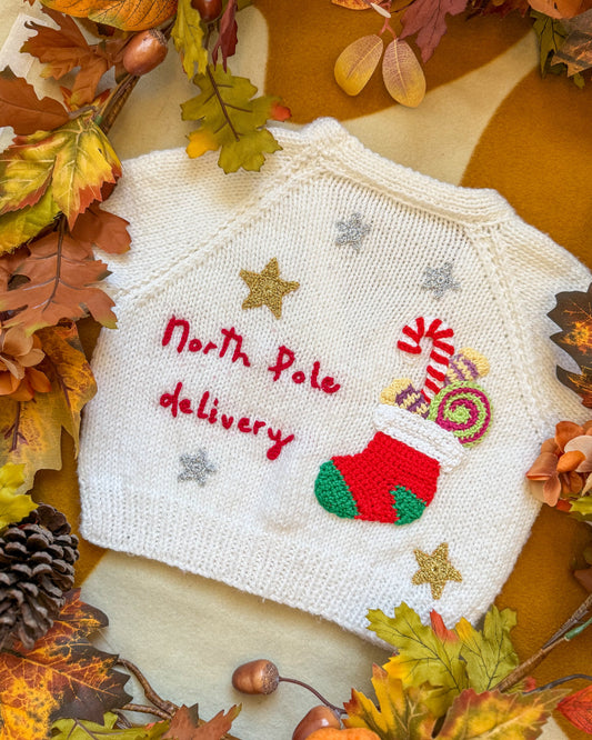 Cute white North Pole delivery cardigan 12-18 months with festive embroidery and decorative details