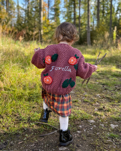 Little Flower Knits personalised kids cardigan hand knitted with orange designs for fashionable children