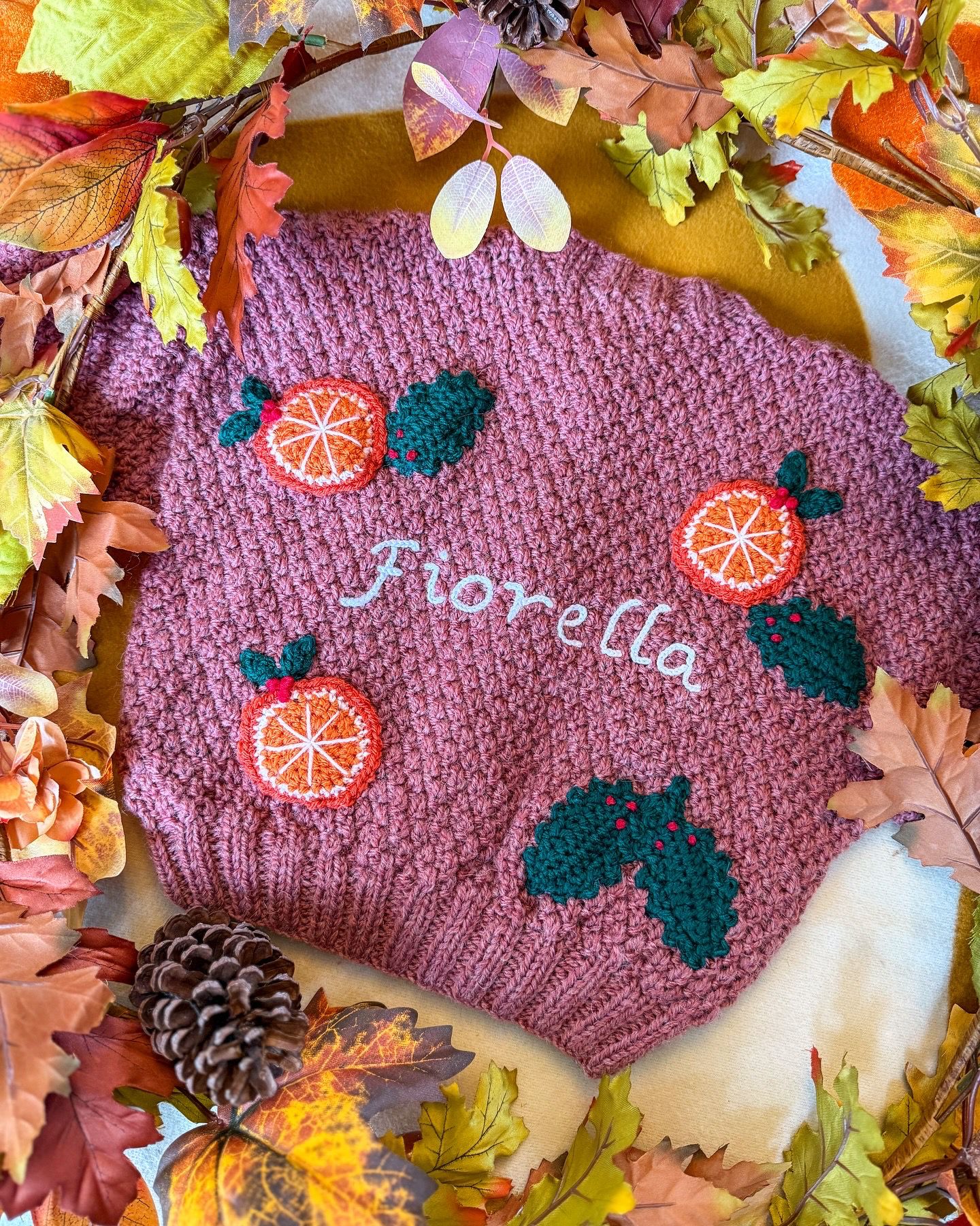 Personalised kids cardigan hand knitted in pink with orange and green embroidery details