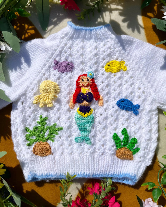 Little Flower Knits white personalised mermaid cardigan with colourful knitted sea creatures and plants