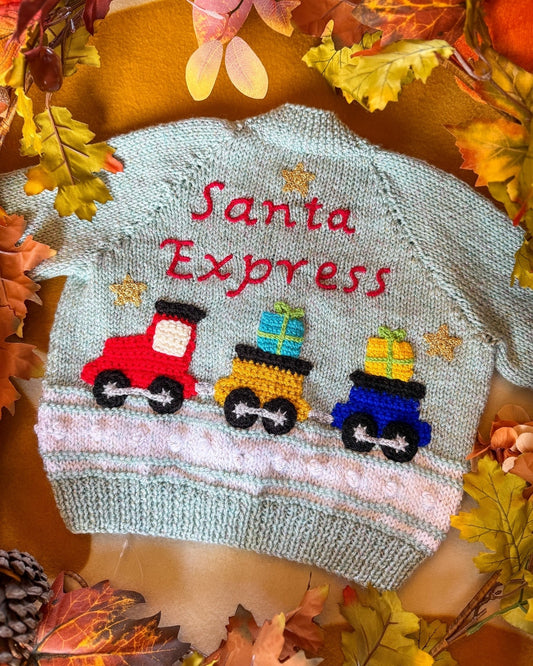 Santa Express baby cardigan with colourful train design and festive gifts on a mint green background
