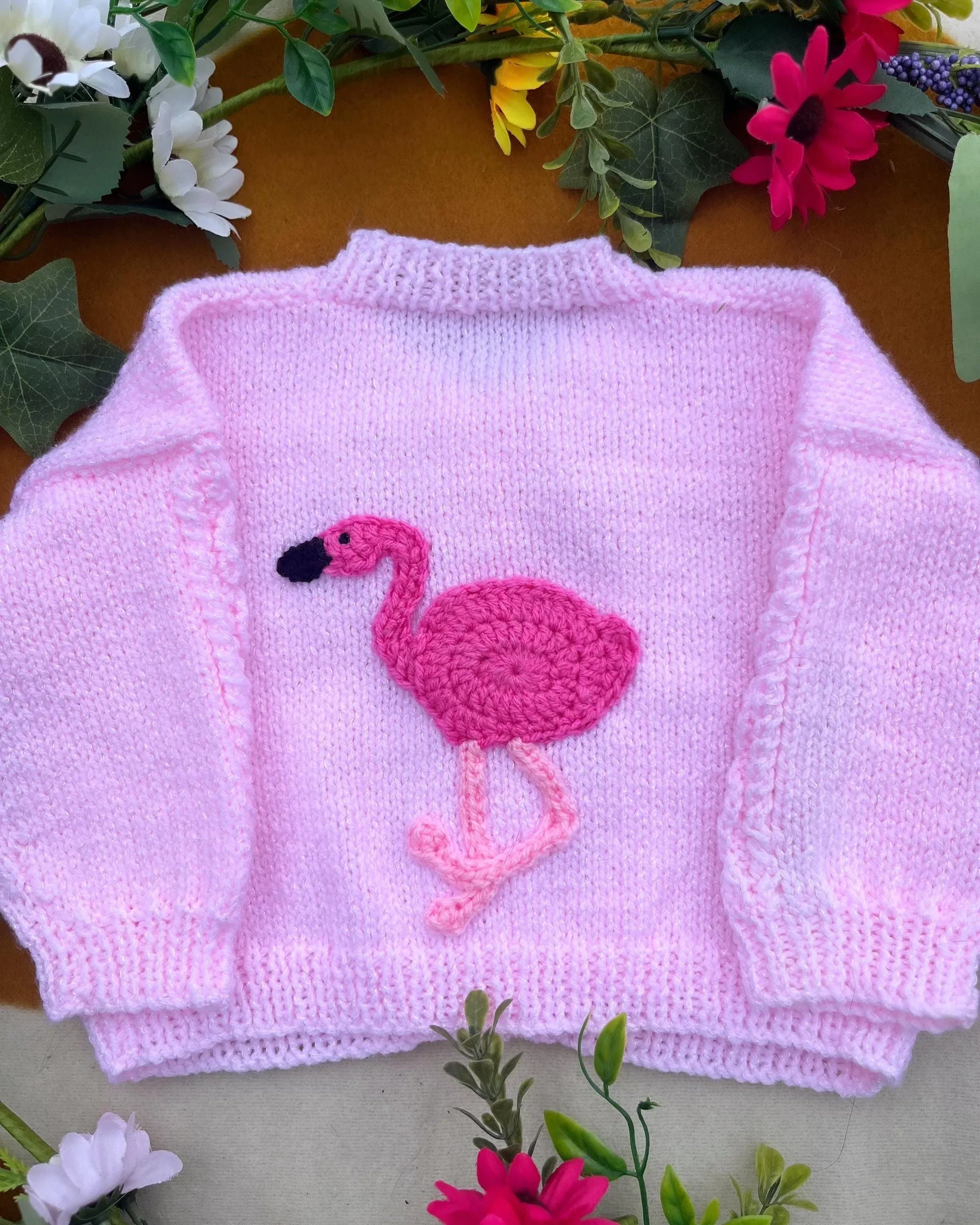 Little Flower Knits sustainable baby gift flamingo cardigan in soft pink with crochet flamingo design