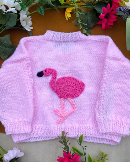 Little Flower Knits sustainable baby gift flamingo cardigan in soft pink with crochet flamingo design