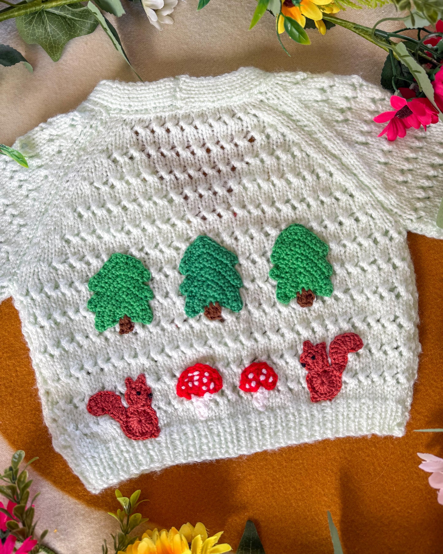 Handmade baby cardigan 9-12 months featuring a cute design with trees, squirrels, and mushrooms