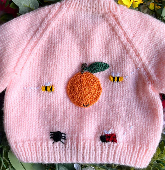 Pink knitted baby jumper with crochet pumpkin and insect buttons unique baby shower gift knitted