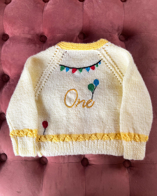 Hand knitted cream and yellow baby cardigan with balloons and One embroidery unique first birthday cardigan gift