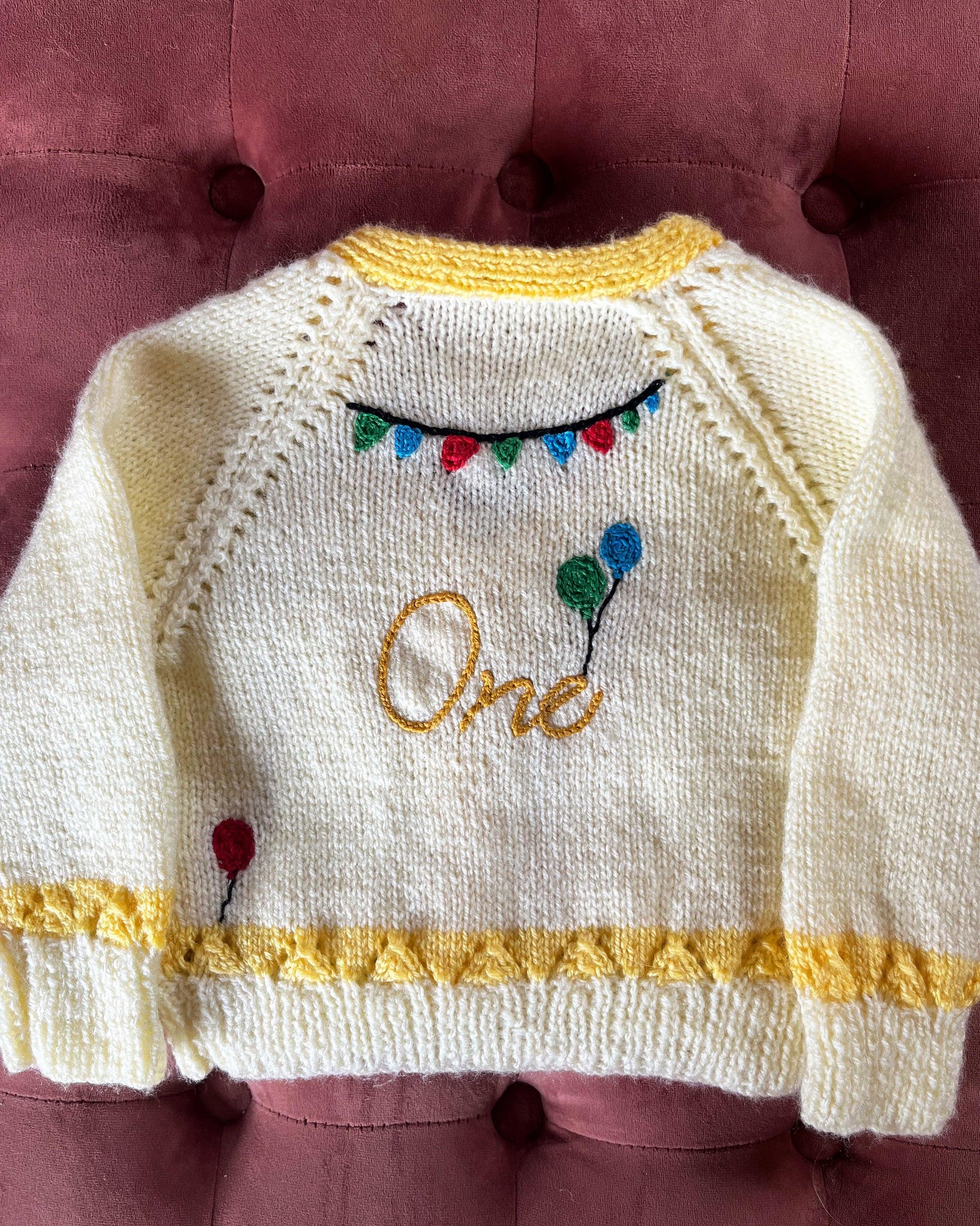 Little Flower Knits white and yellow knitted cardigan with balloons and One text perfect unique first birthday cardigan gift