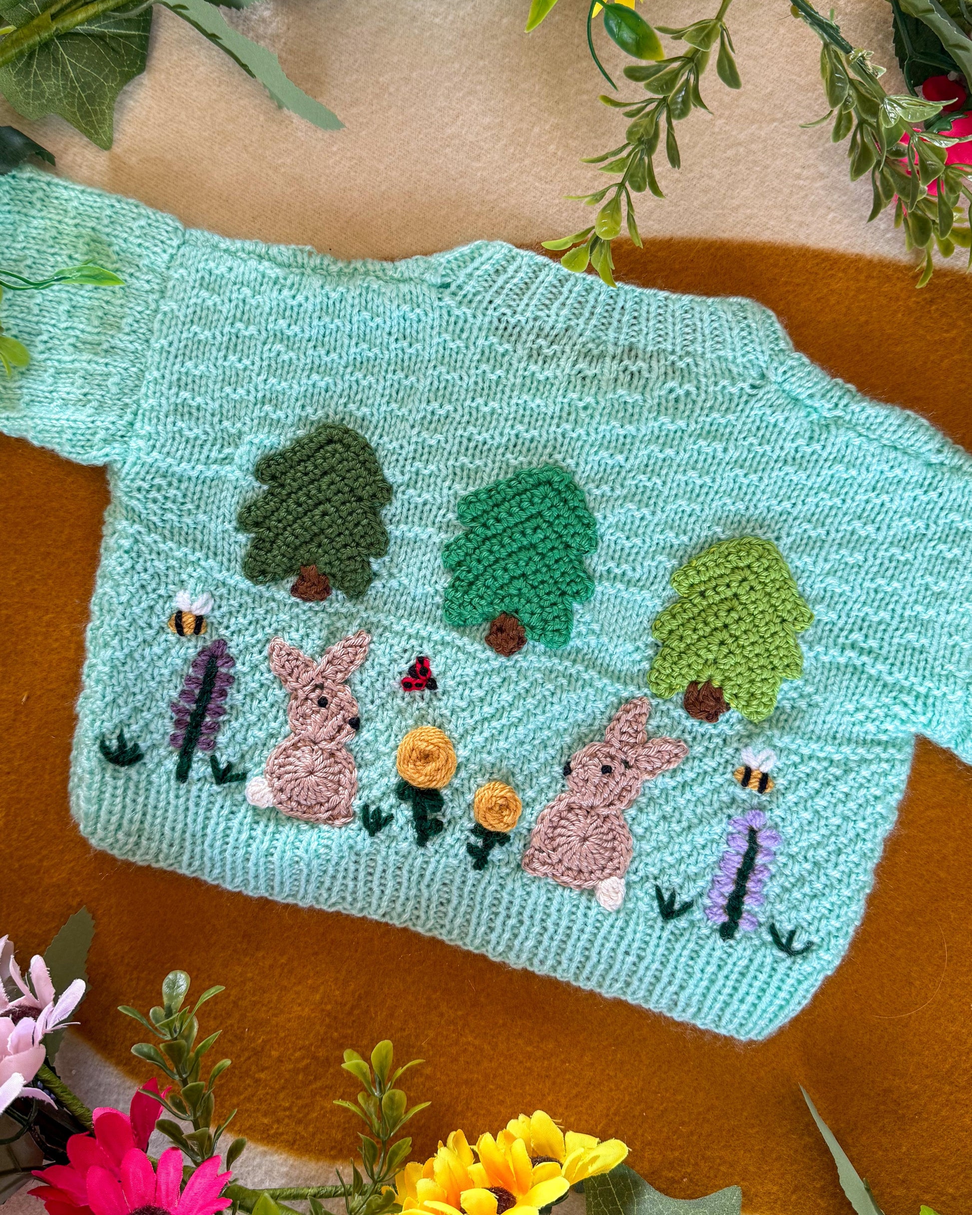 Wildflower meadow baby cardigan in mint green with embroidered trees and rabbits design