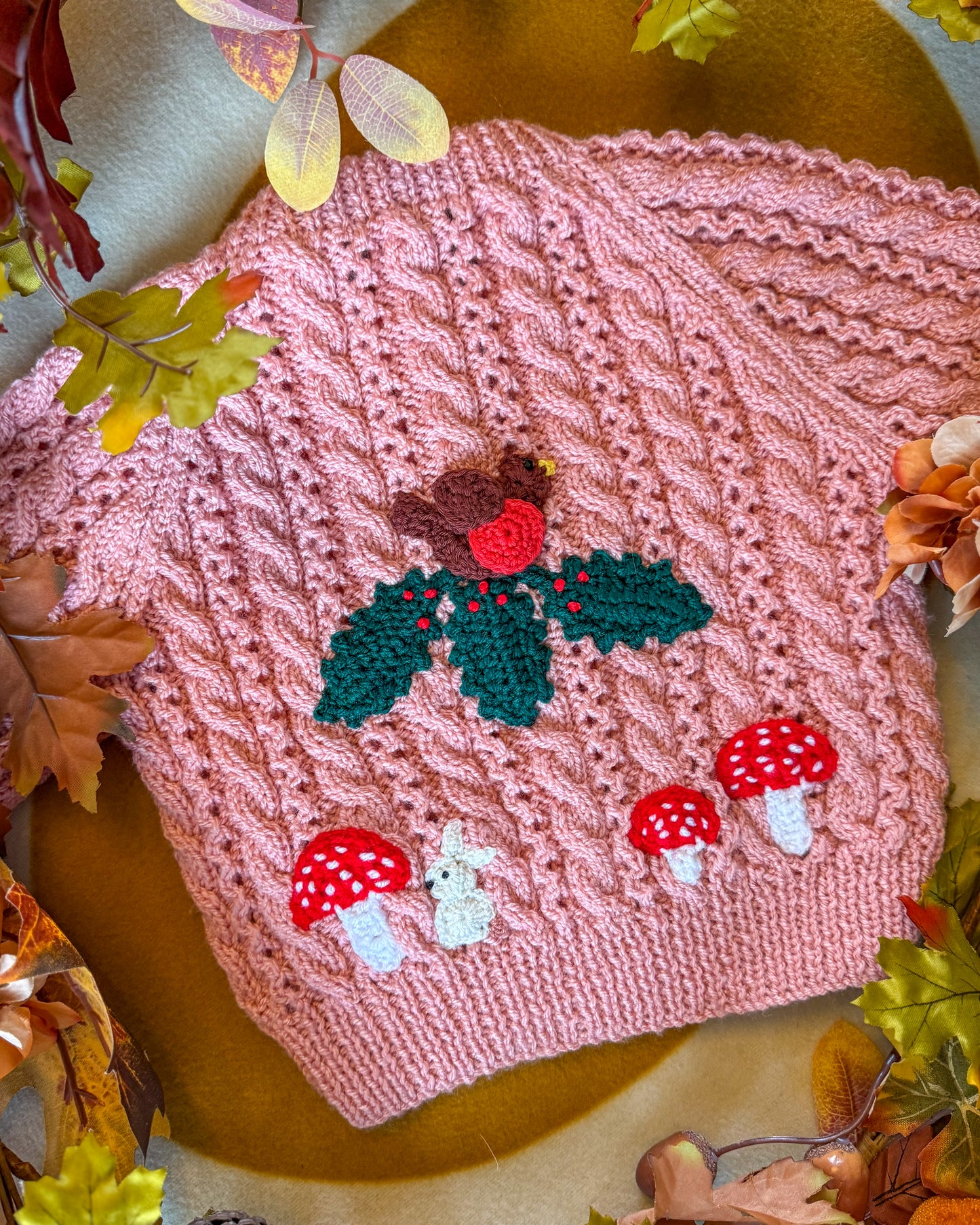 Hand-knitted winter woodland cardigan for toddlers featuring a knitted bird and toadstools