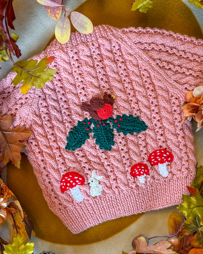 Hand-knitted winter woodland cardigan for toddlers featuring a knitted bird and toadstools