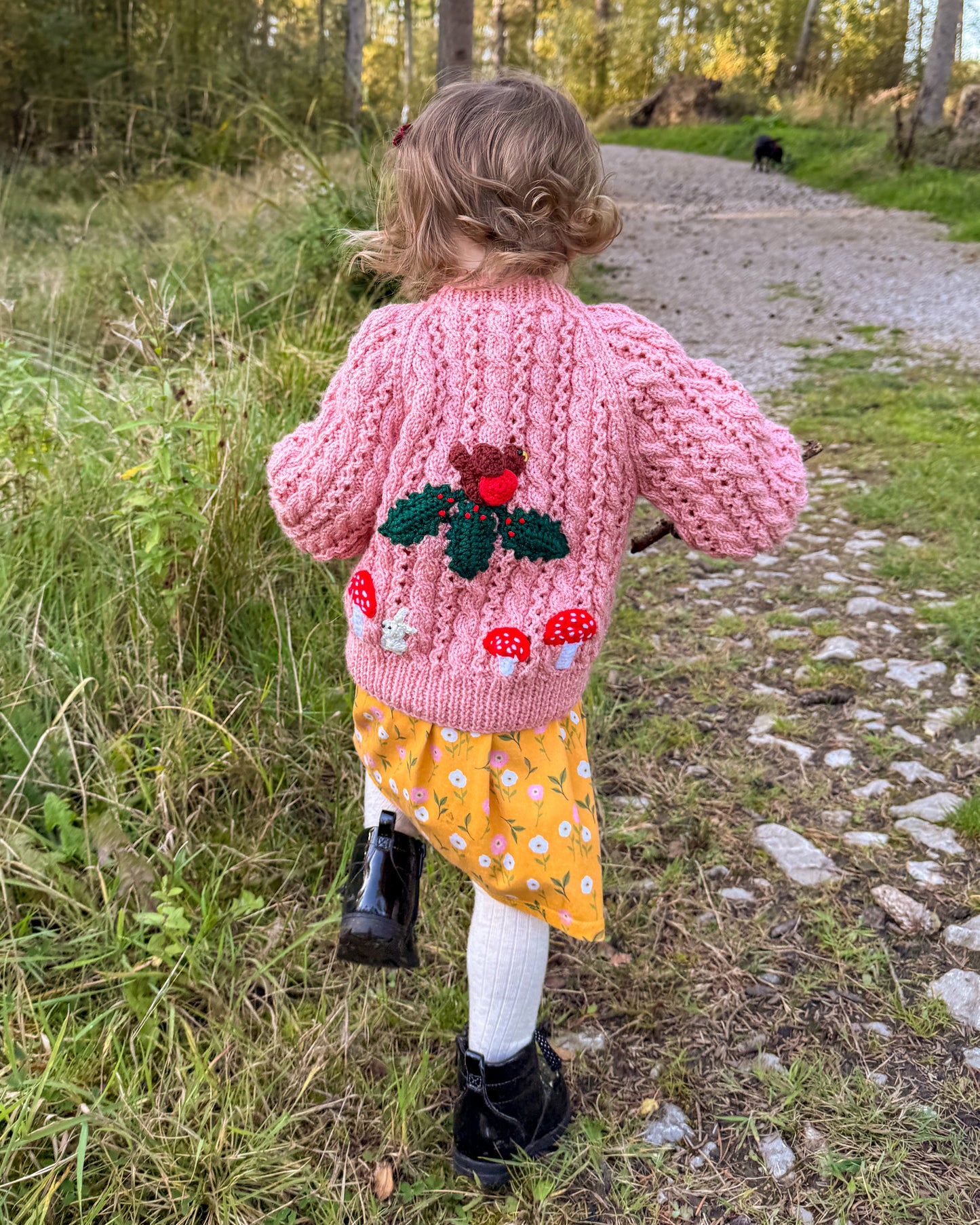 Woodland themed kids cardigan by Little Flower Knits with a pink knitted design and mushroom embroidery