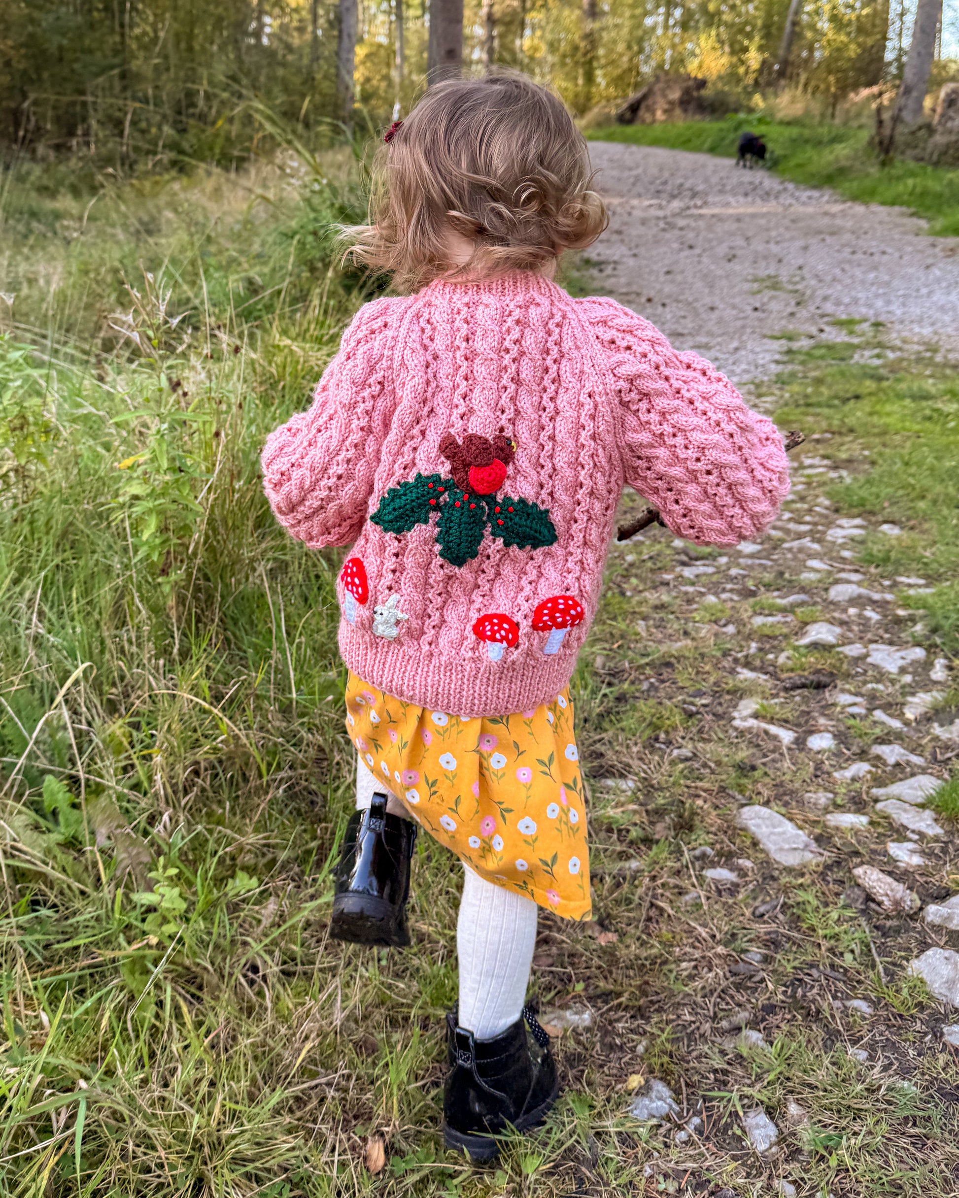 Woodland themed kids cardigan by Little Flower Knits with a pink knitted design and mushroom embroidery